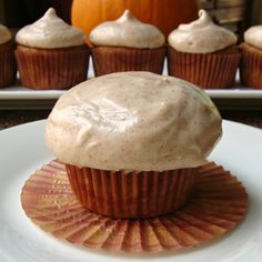 cupcakes with frosting sitting on a plate