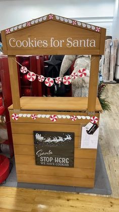 a wooden box with candy canes on it and a sign that says cookies for santa