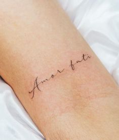 a person with a tattoo on their arm that says, annotata in cursive writing