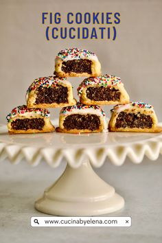 there are many pieces of cake on top of the cake stand with sprinkles