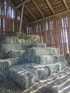 hay bales are stacked up in a barn