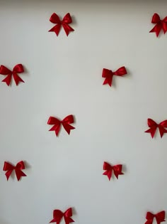 several red bows are arranged on the wall