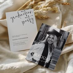 graduation announcement card with graduate photo on it next to an open book and dried plant