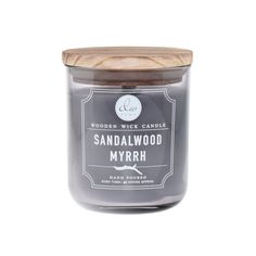 a jar of sandalwood myrrh candle with a wooden lid on a white background