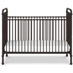 a baby crib that is black and has white sheets on the bottom, with an iron frame