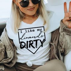 a woman sitting in the back seat of a car wearing a white shirt that says i like my diamond dirty