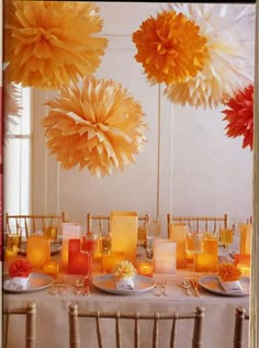 the table is set up with paper pom - poms