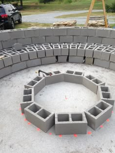 a circle made out of cinder blocks in the sand