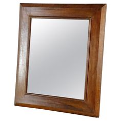 a wooden framed mirror on a white background