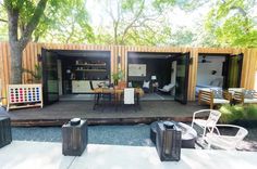 an outdoor living area with chairs and tables