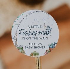 a little fisherman is on the way baby shower sign with an arrow in front of it