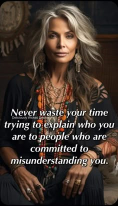 a woman with long hair and jewelry on her neck, sitting in front of a clock