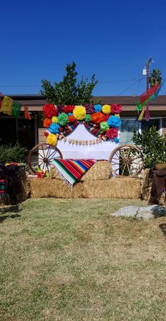 hay bales and decorations in front of a house