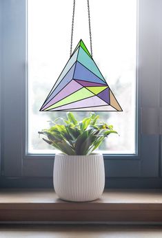 a potted plant sitting on top of a window sill