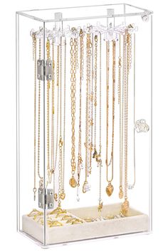 a jewelry rack with many different necklaces hanging from it's sides and on display