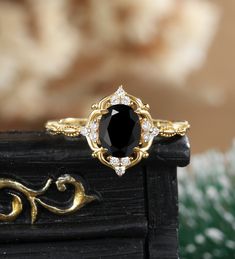 a black diamond ring sitting on top of a wooden table