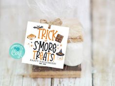 there is a small treat in a glass jar with a tag that says trick s'more treats happy halloween