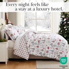 a bed with white sheets and christmas decorations in front of a window that says, every night feels like a stay at a luxury hotel