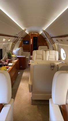 the inside of an airplane with white leather seats