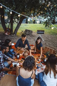 a group of people sitting around a picnic table