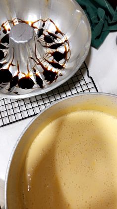 a pan filled with food sitting on top of a counter next to a frying pan