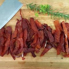 chopped meat on a cutting board next to a knife