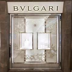 an elegant display case in the window of a luxury store with glass doors and windows