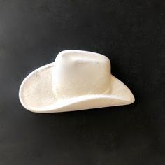 This Cowboy Hat (Magnet) is small enough to be a fridge magnet and come with a magnet to attach after firing! Bisque fired once and ready to paint or glaze. Use Mayco Wonderglazes before your final Mayco Clear One glaze firing for a microwave, dishwasher, and oven-safe finish. Cowboy Hat (Magnet) is: Fired once to bisque stage, ready to paint or glaze & re-fire 1.75" L x 1" W x .25" H Ready to paint with Mayco Underglaze, clear coat and fire. Available for purchase as a ceramic blank for in-stud Magnets For Fridge, Cute Magnets, Fridge Magnet, Cowboy Hat, Cowboy Hats, Glaze, Magnets, Cowboy, Paint