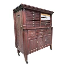 an old fashioned wooden cabinet with drawers on wheels