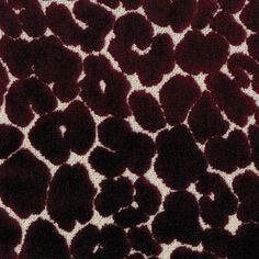 a red and white animal print rug with black spots on the top, in an area that looks like it could be used for carpeting