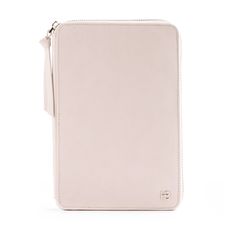 a white ipad case sitting on top of a white surface with a zippered closure