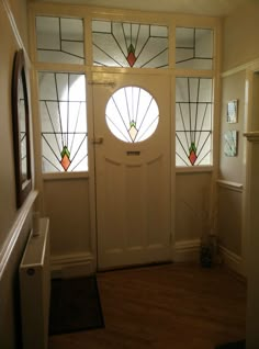 a white door with two stained glass windows