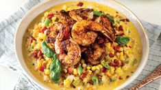 a white bowl filled with shrimp and corn