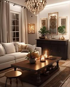 a living room filled with furniture and a chandelier hanging from the ceiling over a coffee table