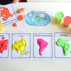 children's hands are painting the map of the world with different colors and shapes