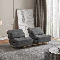 a living room with two gray chairs and a coffee table