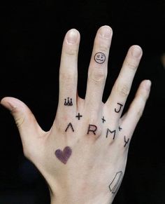 a person's hand with tattoos on it and the word army painted on their palm