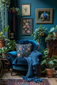 a living room filled with lots of plants next to a blue couch and rug on top of a hard wood floor