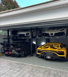 two cars are parked in the garage with their doors open