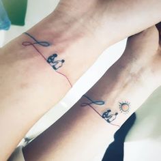 two people with matching tattoos on their legs, one is holding the other's hand