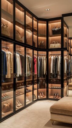 a walk in closet filled with lots of clothes and bags on shelves next to a couch