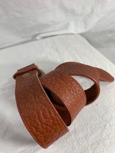 "You are looking at a genuine leather belt by Leatherock USA. Belt is size medium to large and measures 38\" long, 1\"2 wide, with 28\" 4 from the first perforation and 32\"4 at it's last perforation. Buckle measures 3\"1 wide X 2\"2 at it's highest. There are a few light scuffs with no tears. The condition of this belt is good with great detail, brass tone hardware with several stones and rhinestones. 100% genuine Leatherock made in USA. I want to stress that item is vintage which means it's no Adjustable Belts With Antique Buckle For Everyday Use, Adjustable Brown Belt With Self Belt Detail, Adjustable Brown Leather Belt, Adjustable Brown Belt, Adjustable Brown Leather Belts And Suspenders, Adjustable Leather Belted Belts And Suspenders, Adjustable Brown Belt With Antique Buckle, Brown Adjustable Belts And Suspenders With Antique Buckle, Leather Belts And Suspenders With Antique Buckle