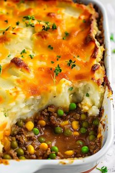 a casserole dish with meat, peas and cheese