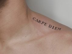 a man with a tattoo saying carpe diem on his chest