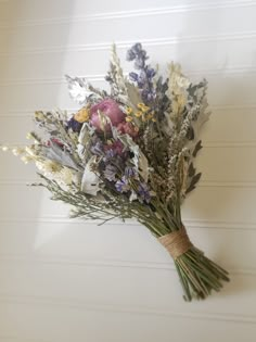 a bunch of flowers sitting on top of a white wall