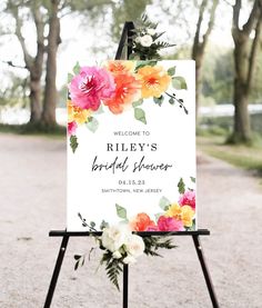 a sign with flowers on it that says, welcome to riley's bridal shower