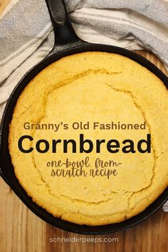 a skillet filled with cornbread on top of a wooden table