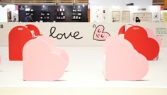 there are many pink hearts on display in the store's showroom, and one is for sale