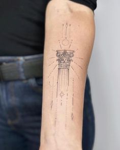 a woman's arm with a tattoo on it that has an image of a clock