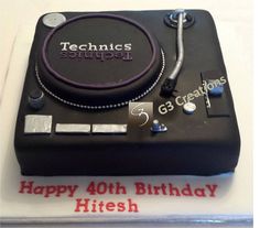 a birthday cake that is shaped like a record player with the words technics on it